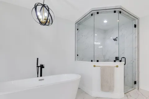 a bathroom with a sink a mirror and shower