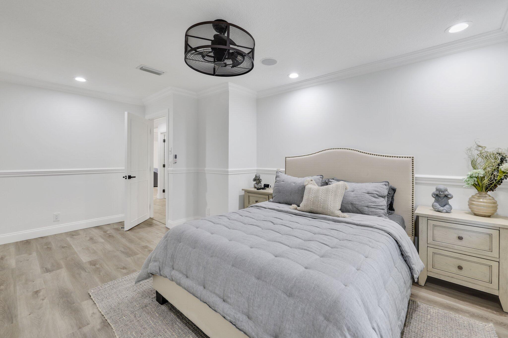 7811 Mandarin Drive Boca Raton, FL 33433 - Photo 29 of 51 a bedroom with a bed and a chandelier