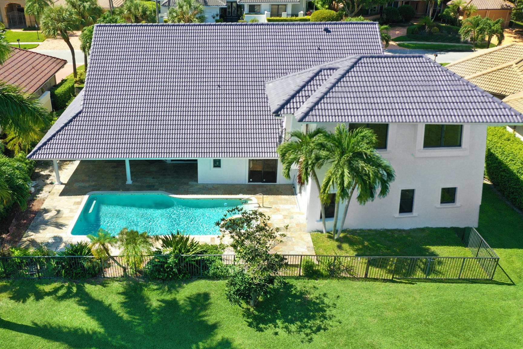 7811 Mandarin Drive Boca Raton, FL 33433 - Photo 3 of 51 a front view of a house with a yard