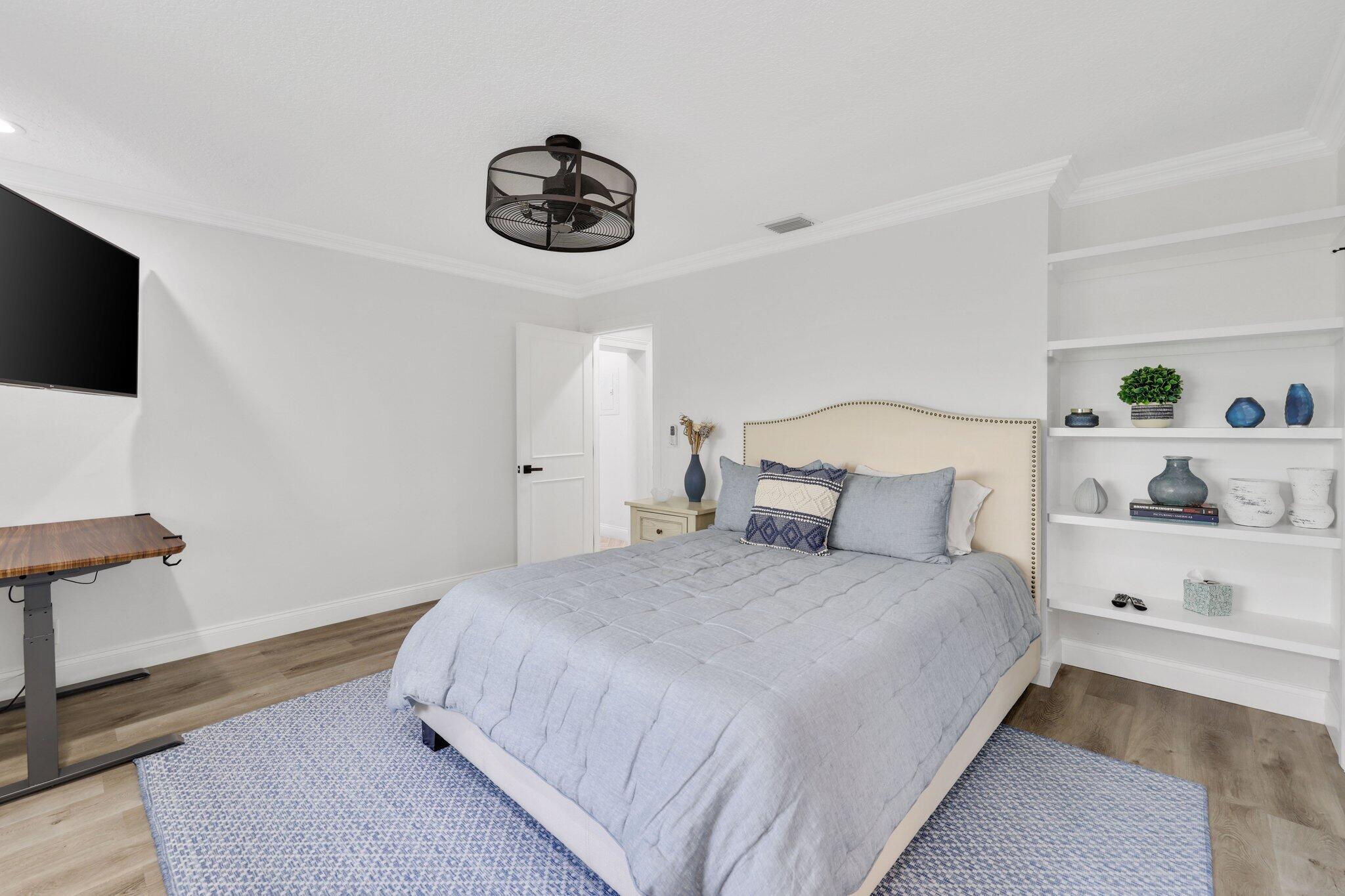 7811 Mandarin Drive Boca Raton, FL 33433 - Photo 32 of 51 a bedroom with a bed and a flat screen tv