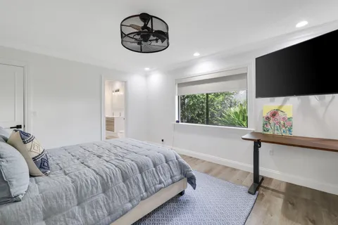 a bedroom with a bed and a flat screen tv