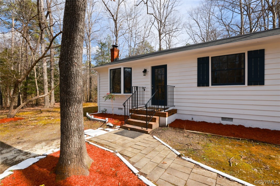 6706 Belmont Road Chesterfield, VA 23832 - Photo 9 of 43 a view of a backyard with chair and wooden floor