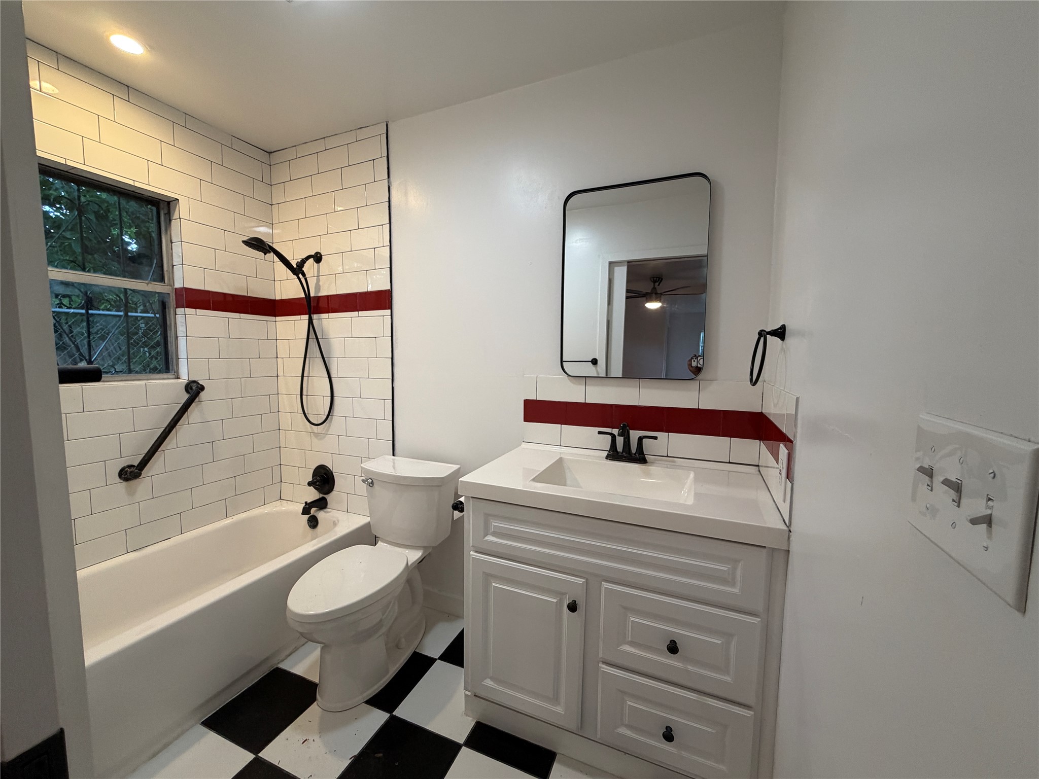 1060 Gardner Road Austin, TX 78721 - Photo 11 of 19 Bold checkered flooring and classic subway tiles create a striking, refreshed bathroom aesthetic.