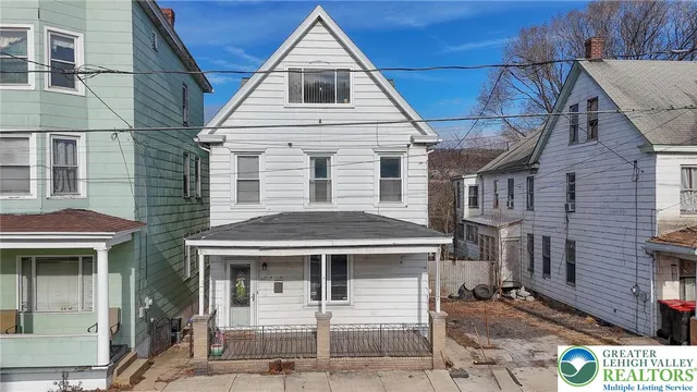 a view of a house with a door and wooden floor
