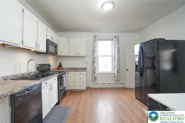 an empty room with windows and closet