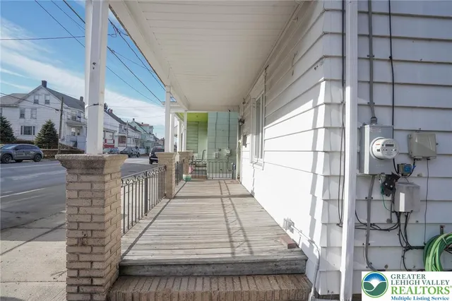 a kitchen with granite countertop a refrigerator stove and sink with wooden floor