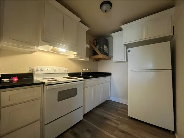 a kitchen with a refrigerator and a stove