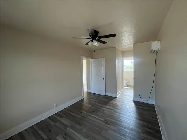 a view of an empty room and wooden floor
