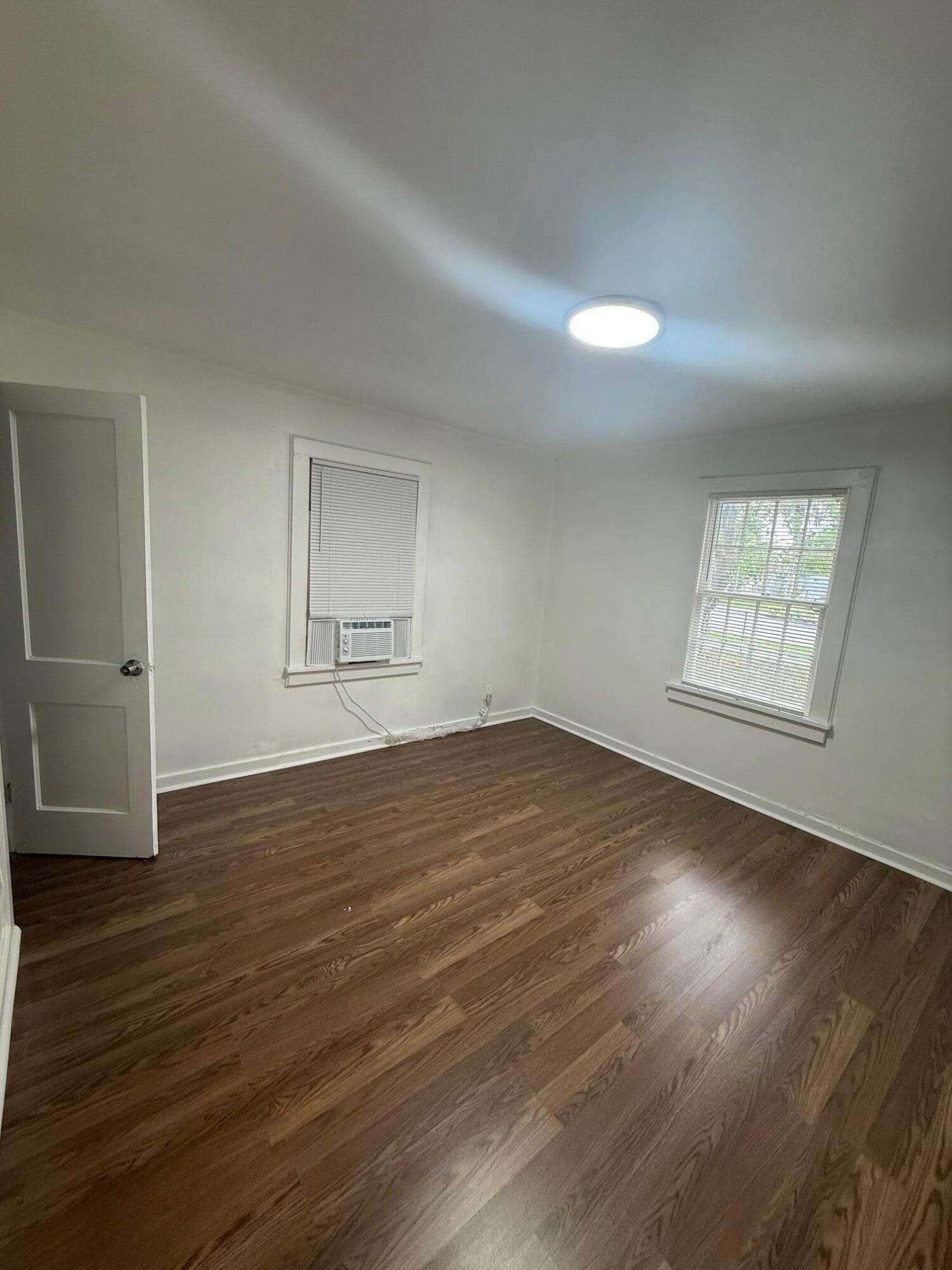 33 Southwest 12th Avenue Delray Beach, FL 33444 - Photo 11 of 17 an empty room with wooden floor and windows