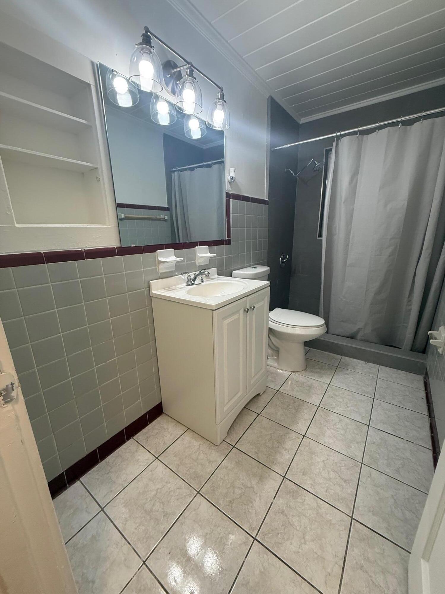 33 Southwest 12th Avenue Delray Beach, FL 33444 - Photo 17 of 17 a bathroom with a sink a toilet and a mirror