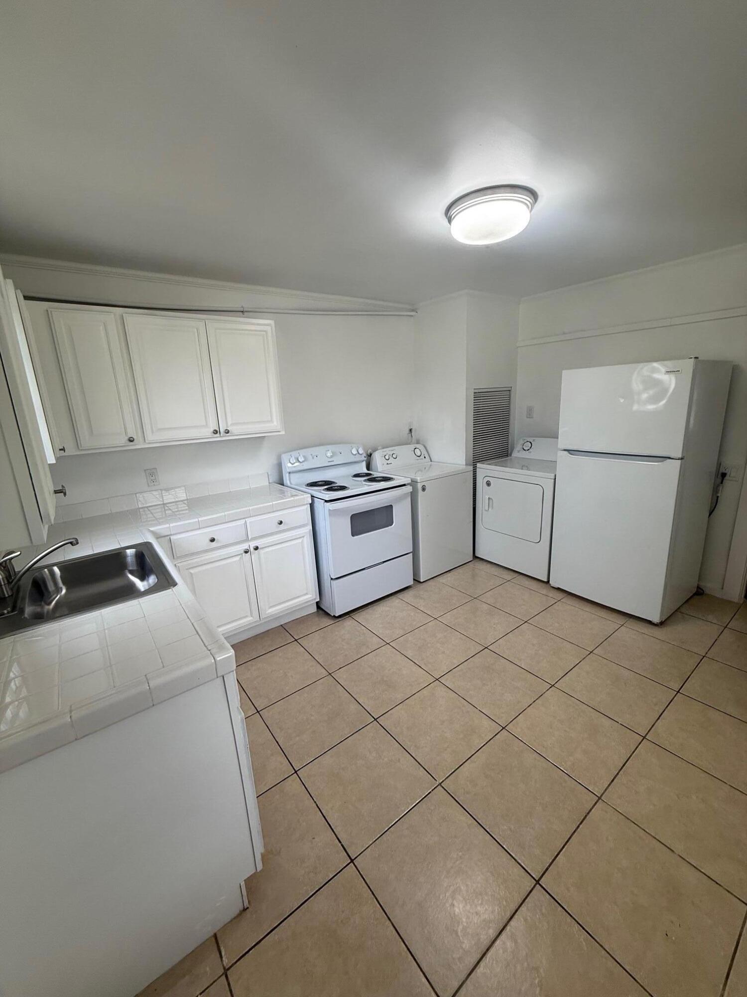 33 Southwest 12th Avenue Delray Beach, FL 33444 - Photo 8 of 17 a room with a washer and dryer