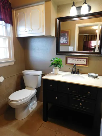 a bathroom with a toilet sink and mirror
