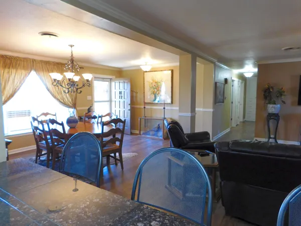 a view of a dining room with furniture and chandelier