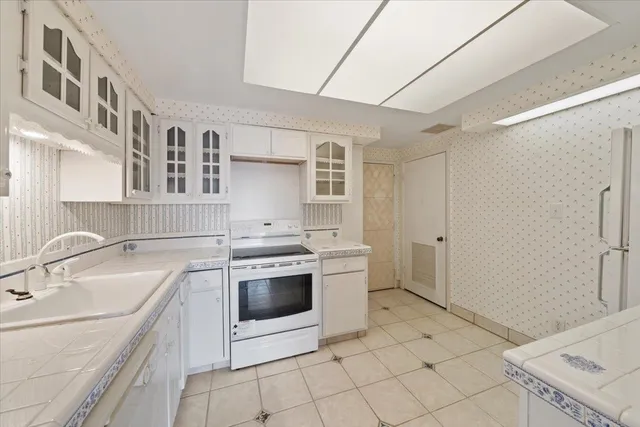 a kitchen with a sink stove and cabinets