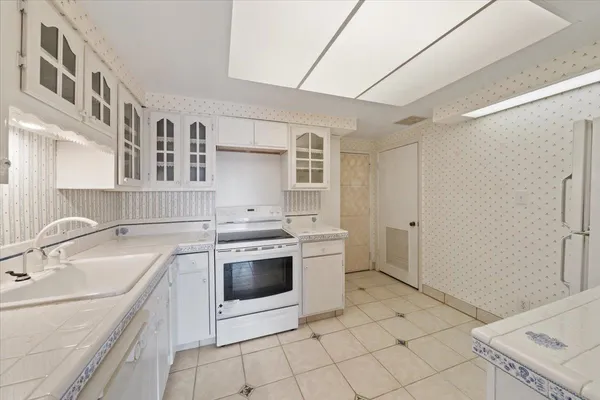 a kitchen with a sink stove and cabinets