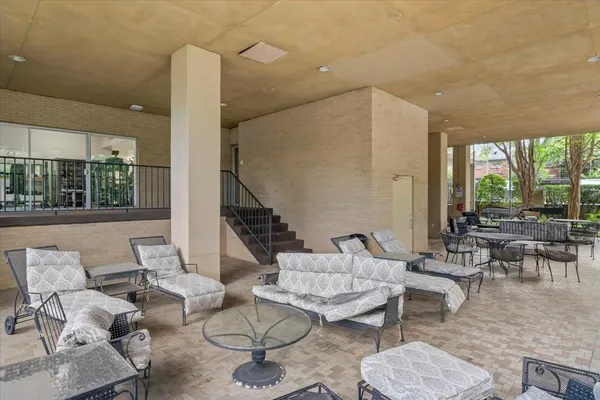 a view of patio with swimming pool and sitting area
