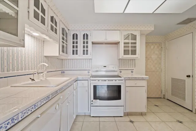 a kitchen with a sink stove and cabinets