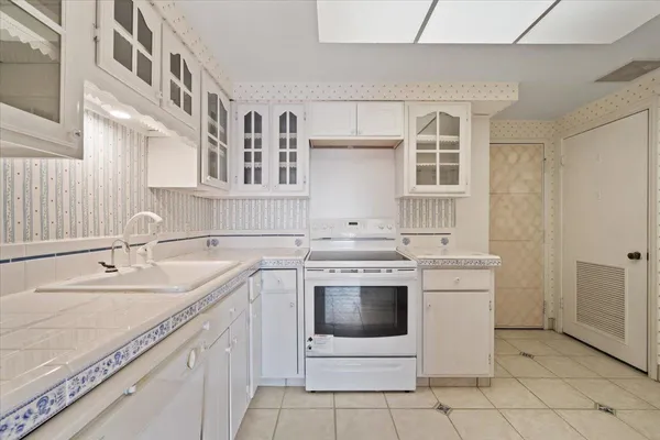 a kitchen with a sink stove and cabinets
