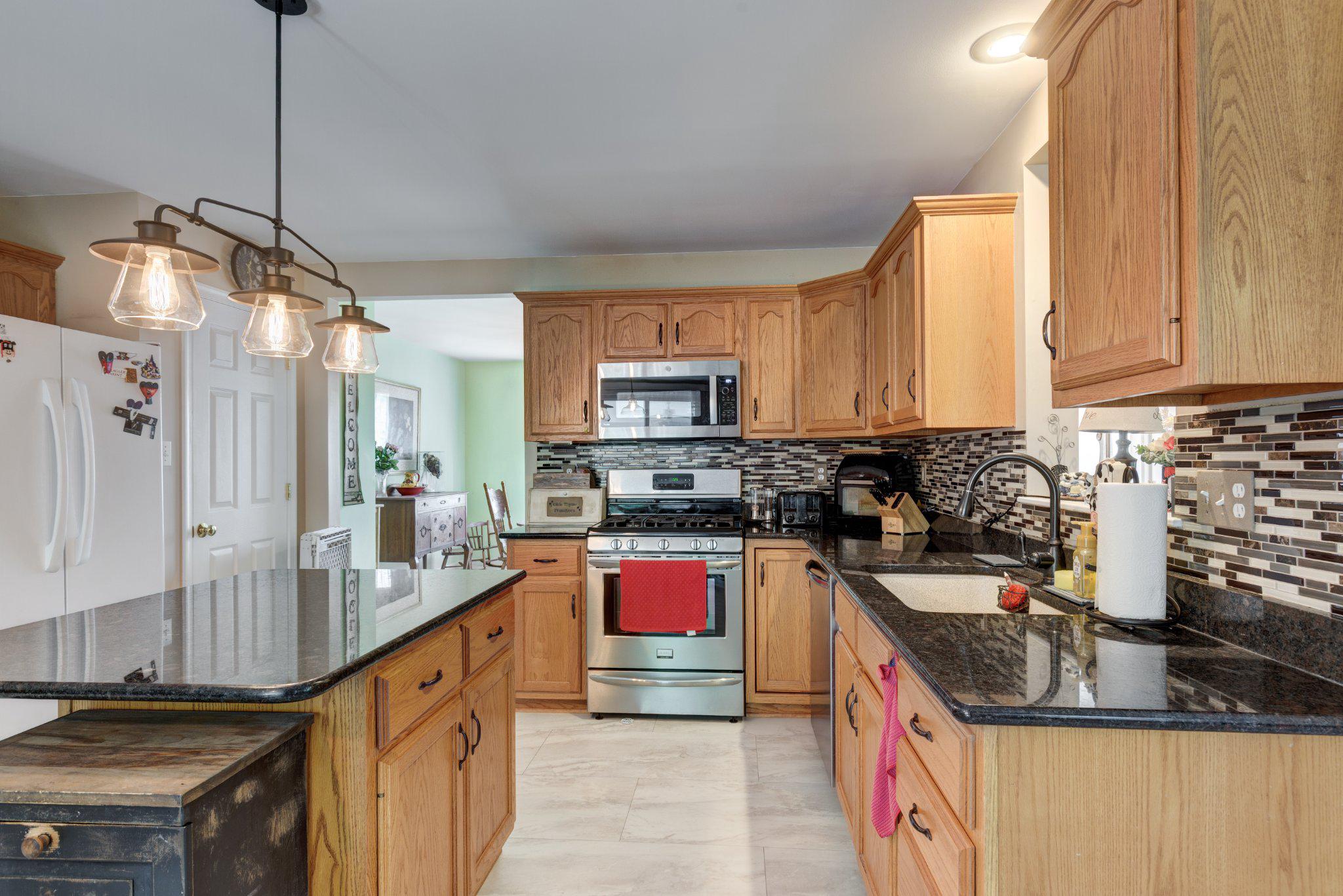 20 Union Street Littlestown, PA 17340 - Photo 11 of 58 a kitchen with kitchen island granite countertop a sink and counter top space
