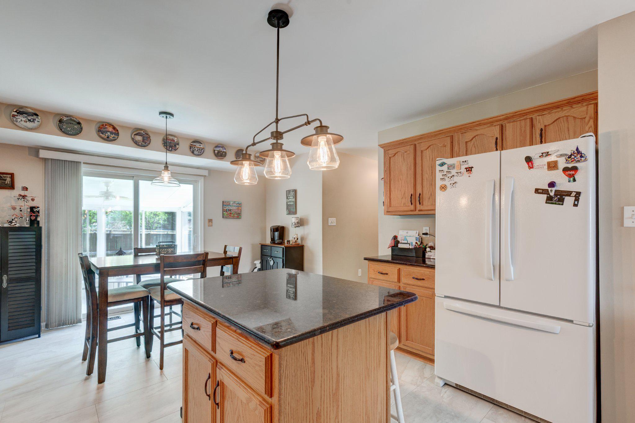 20 Union Street Littlestown, PA 17340 - Photo 14 of 58 a kitchen with stainless steel appliances granite countertop a table chairs and a refrigerator