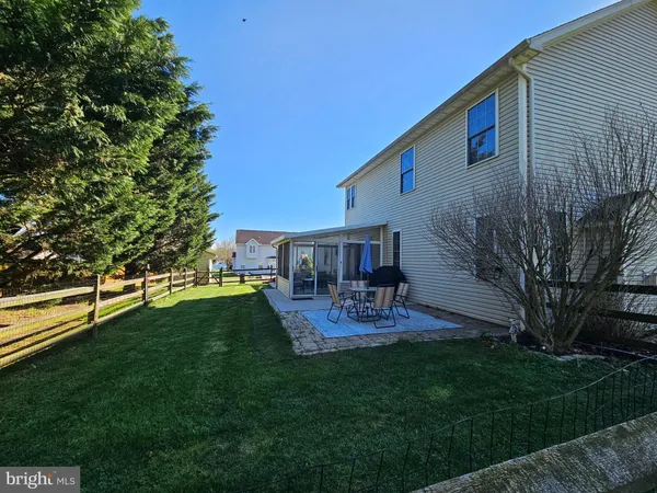 a view of back yard of the house with outdoor seating