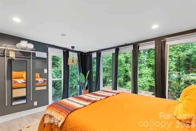 a bedroom with a large bed and a large window