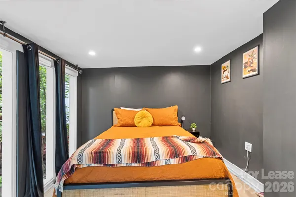 a bedroom with a bed and glass door