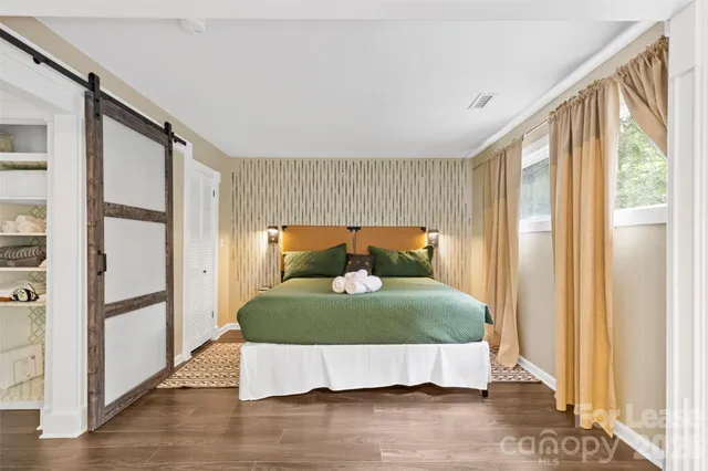 a bed sitting in a room next to a window