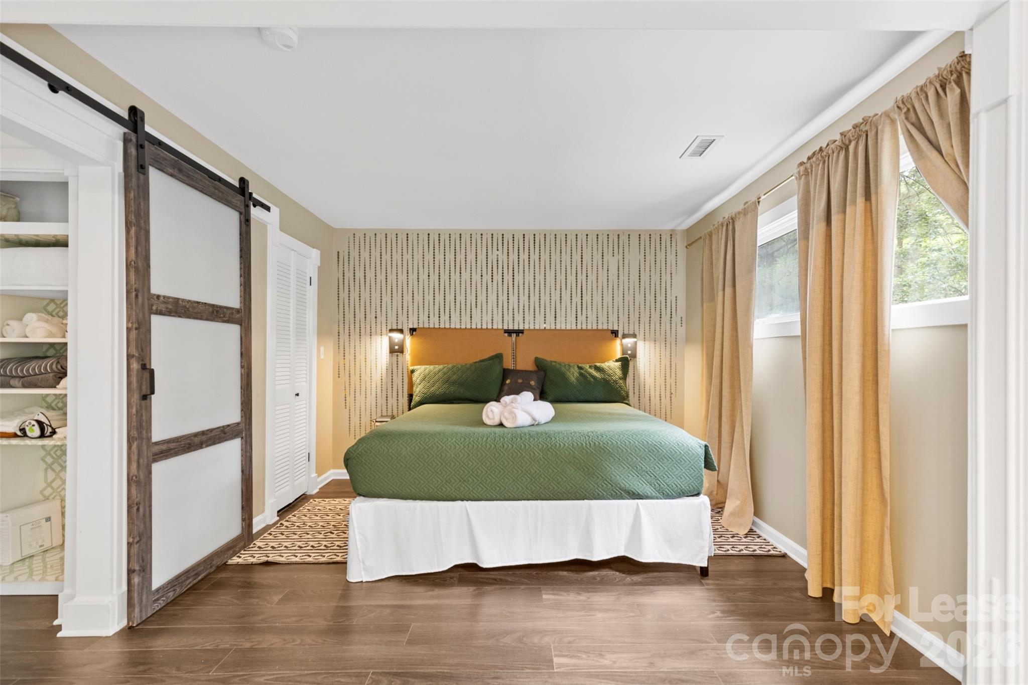 25033 Molokai Drive, Unit UPPR Tega Cay, SC 29708 - Photo 2 of 38 a bed sitting in a room next to a window