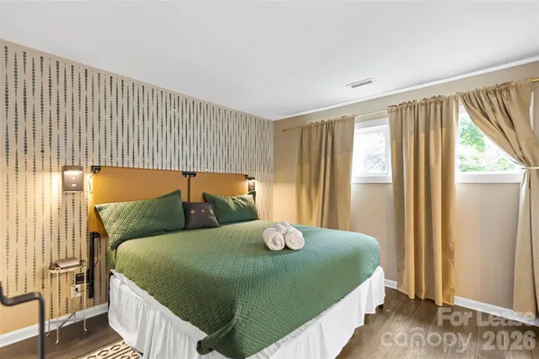 a bedroom with a bed and window