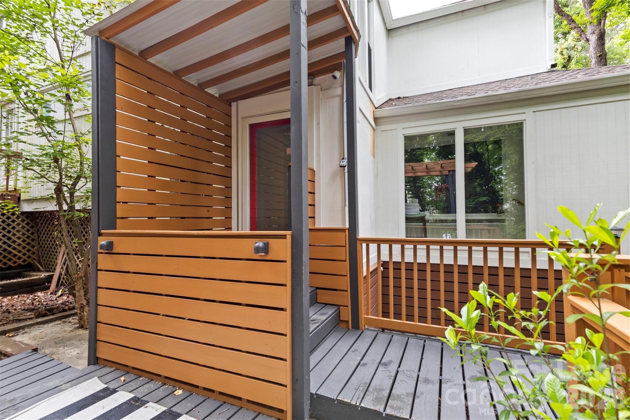 25033 Molokai Drive, Unit UPPR Tega Cay, SC 29708 - Photo 26 of 38 a view of a wooden deck with a bench