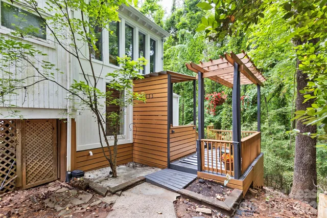a view of a balcony with chairs and wooden fence