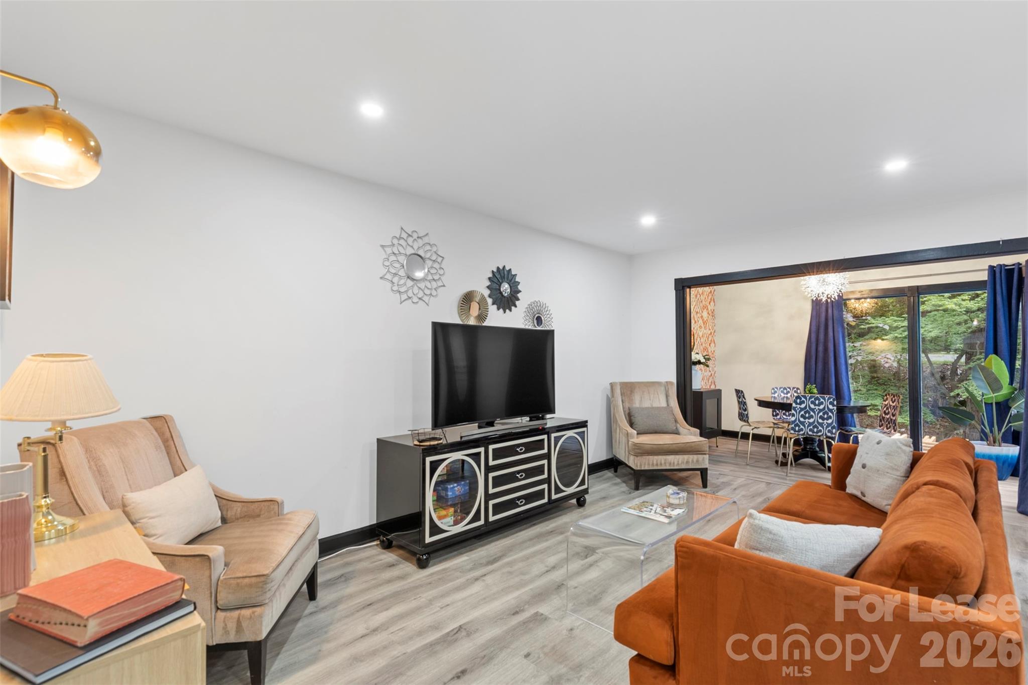 25033 Molokai Drive, Unit UPPR Tega Cay, SC 29708 - Photo 3 of 38 a living room with furniture a flat screen tv and a large window