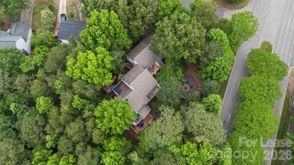 an aerial view of a house with a yard and outdoor seating