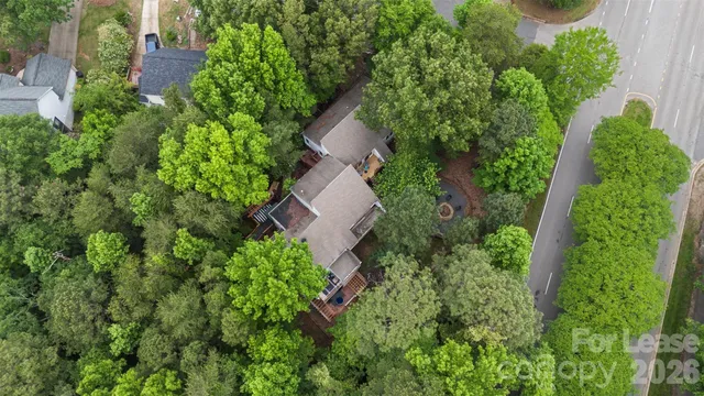 an aerial view of a house with a yard and outdoor seating