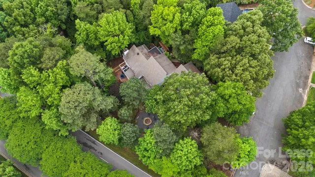 an aerial view of a house with a yard and garden
