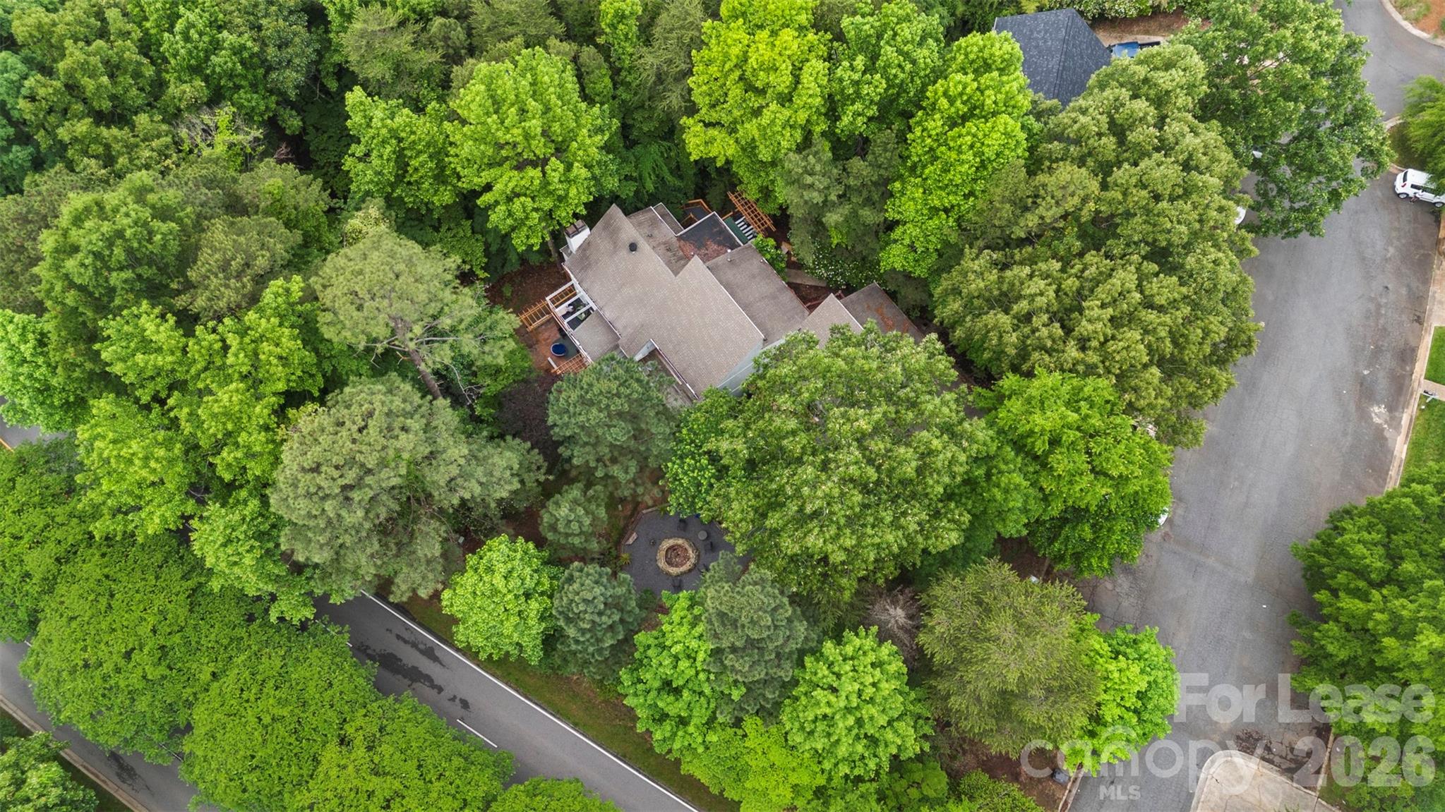 25033 Molokai Drive, Unit UPPR Tega Cay, SC 29708 - Photo 35 of 38 an aerial view of a house with a yard and outdoor seating