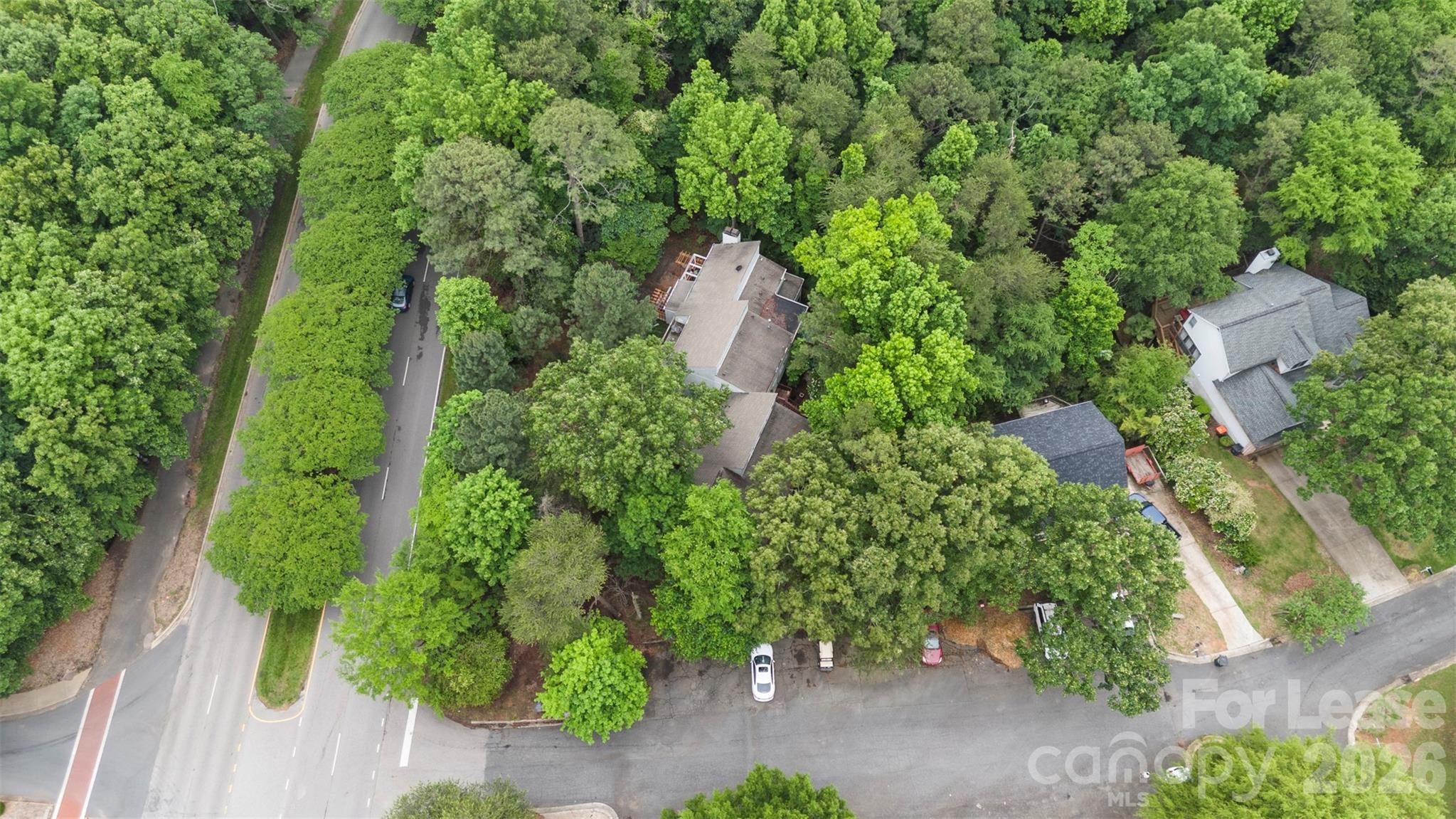 25033 Molokai Drive, Unit UPPR Tega Cay, SC 29708 - Photo 36 of 38 an aerial view of a house with a yard and garden