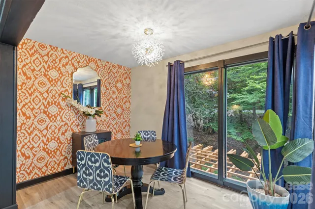 a dining room with furniture a chandelier and a rug