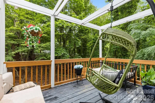 a view of a deck with wooden floor and outdoor seating