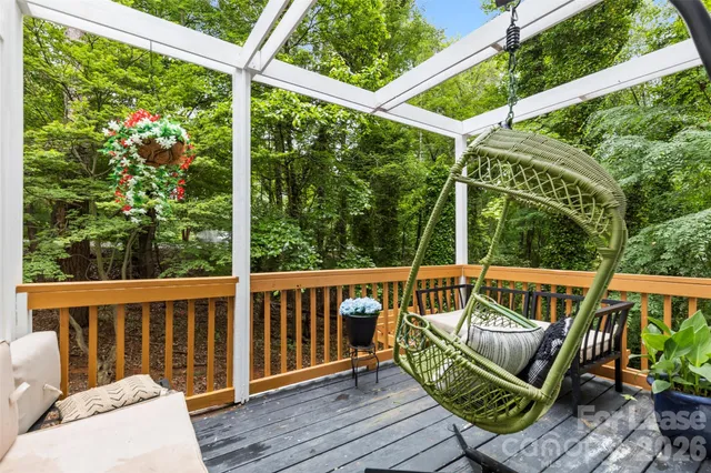 a view of a deck with wooden floor and outdoor seating