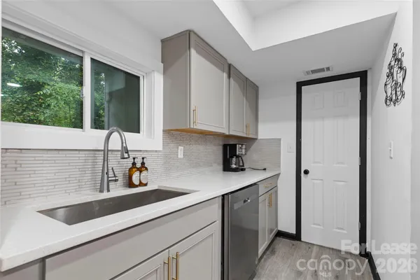 a kitchen with a sink cabinets and window