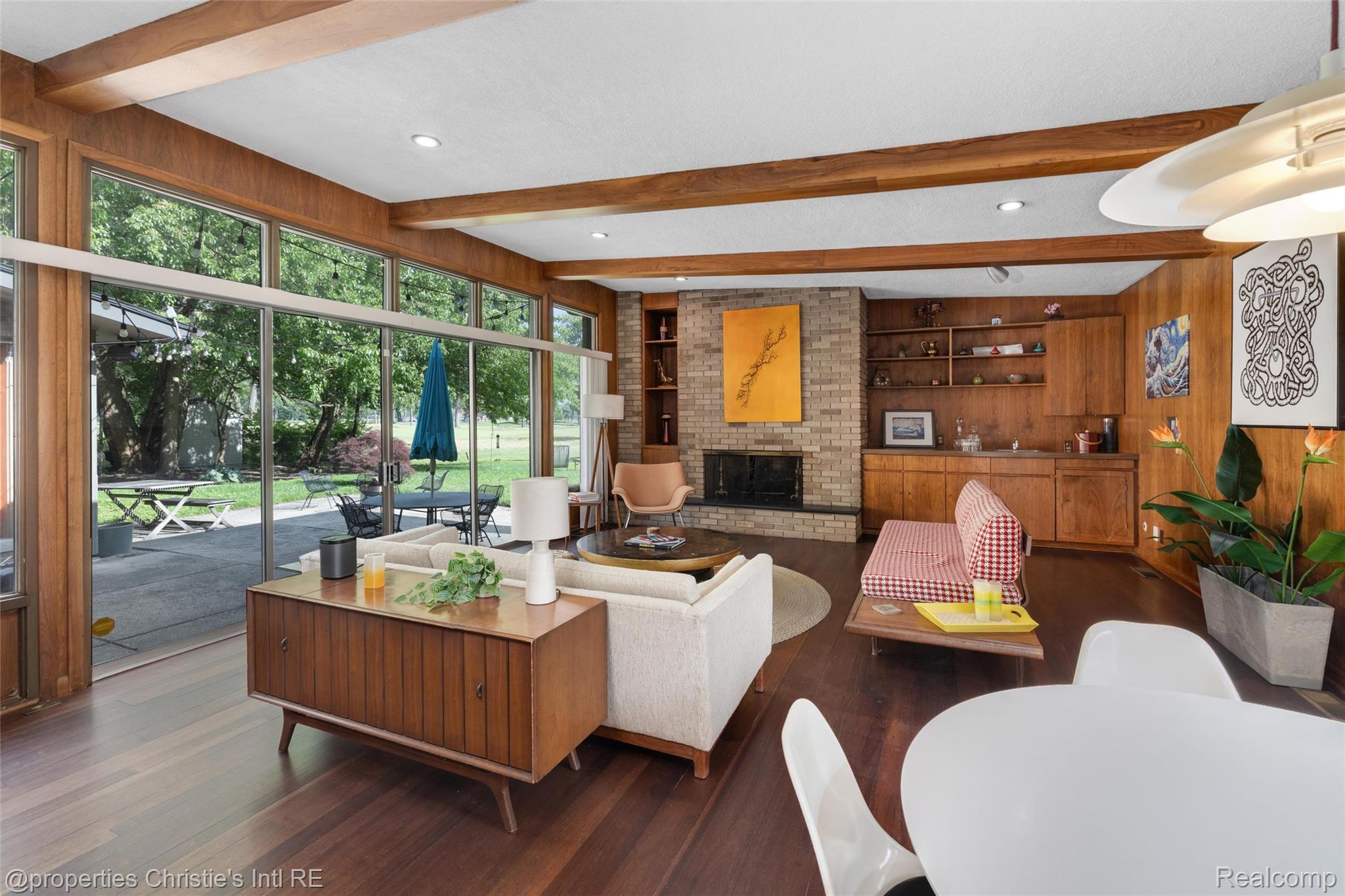 2771 West Seven Mile Road Detroit, MI 48221 - Photo 3 of 57 Open-concept living area with extensive floor-to-ceiling windows, wood-finish flooring, and exposed wood beams