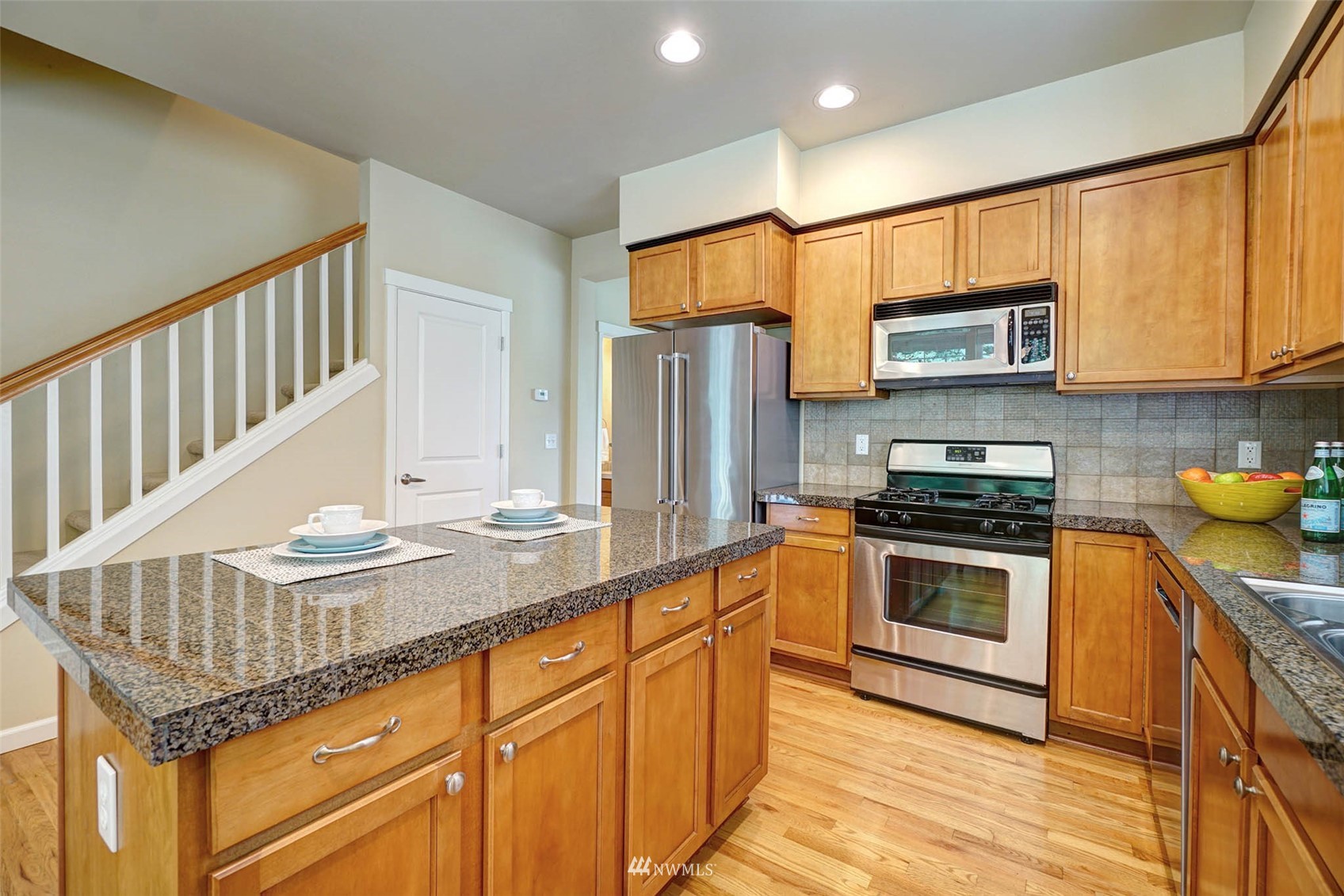 23914 33rd Drive Southeast Bothell, WA 98021 - Photo 8 of 28 a kitchen with stainless steel appliances granite countertop a stove a sink and a refrigerator