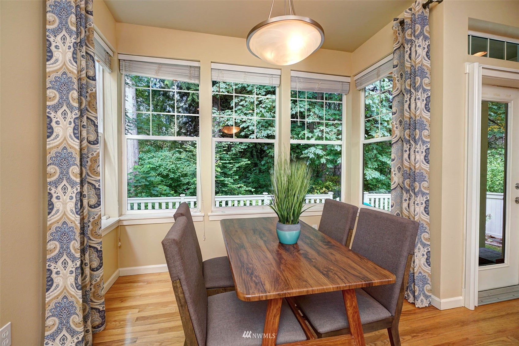 23914 33rd Drive Southeast Bothell, WA 98021 - Photo 10 of 28 a view of a dining room with furniture large windows and wooden floor