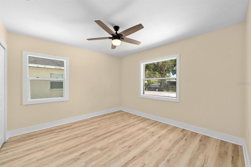 10707 North Rome Avenue Tampa, FL 33612 - Photo 11 of 35 a view of an empty room with wooden floor and a window