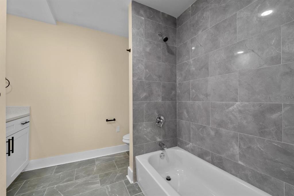 10707 North Rome Avenue Tampa, FL 33612 - Photo 15 of 35 a bathroom with a bathtub
