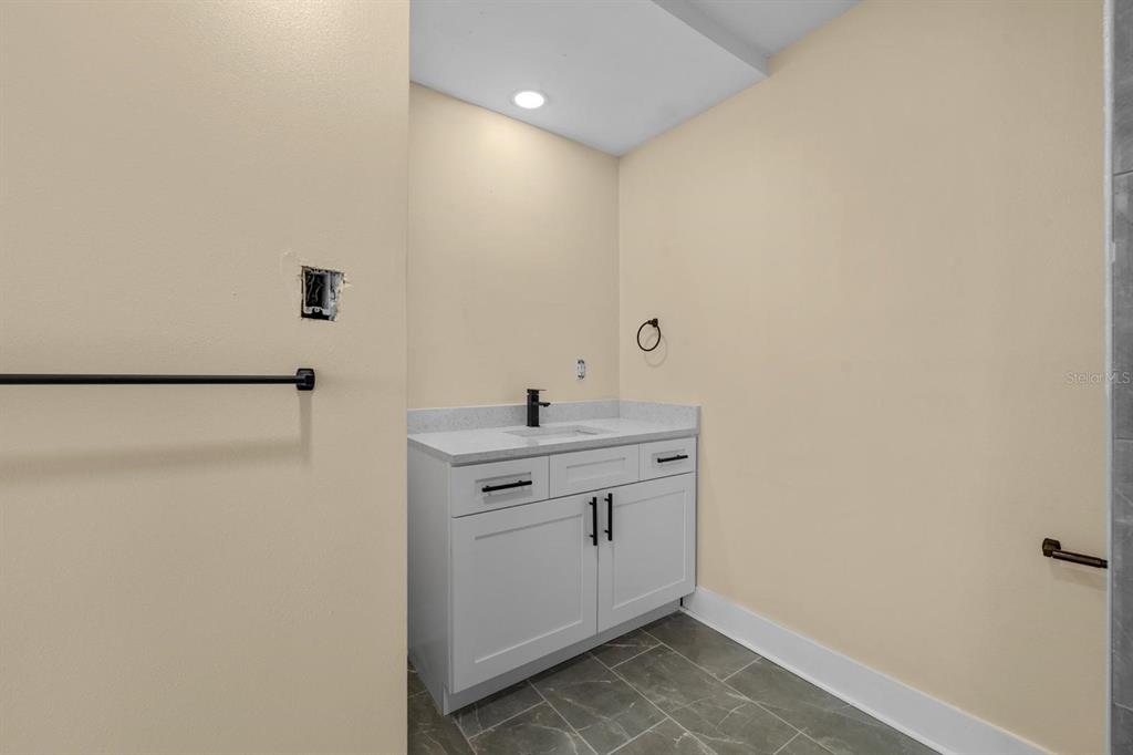 10707 North Rome Avenue Tampa, FL 33612 - Photo 17 of 35 a bathroom with a sink mirror and vanity