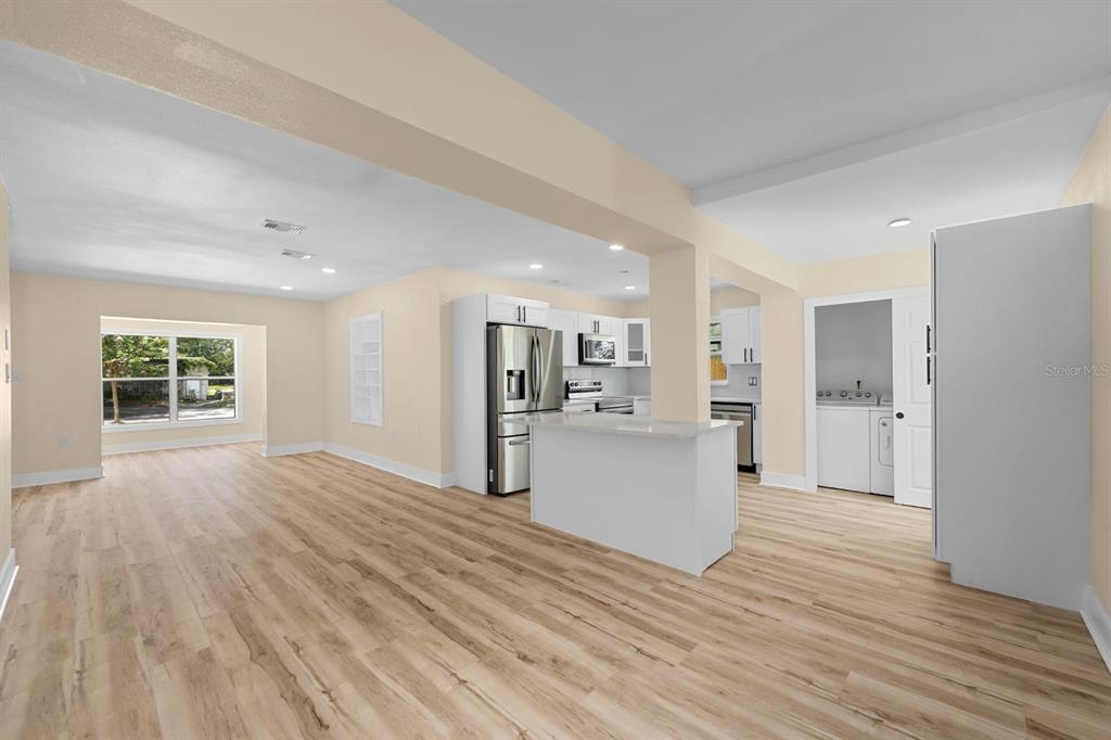 10707 North Rome Avenue Tampa, FL 33612 - Photo 21 of 35 a view of a kitchen with wooden floor and a window