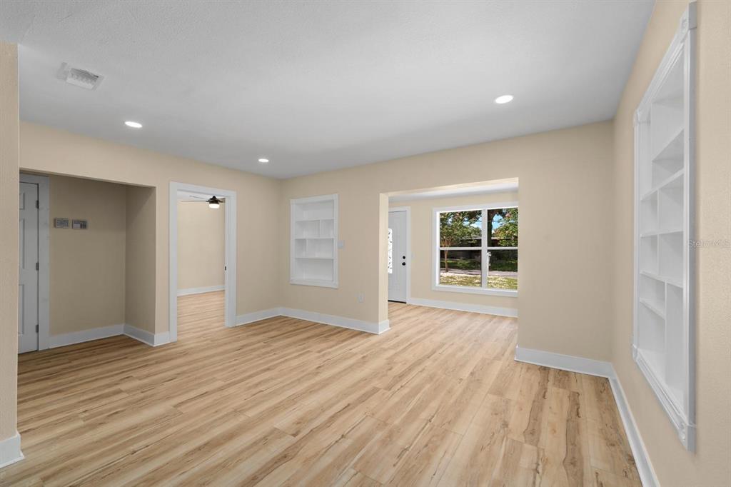 10707 North Rome Avenue Tampa, FL 33612 - Photo 24 of 35 a view of an empty room with wooden floor and a window